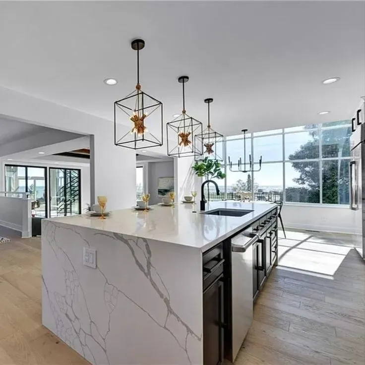 Waterfall edge island with charcoal cabinets in a Parma Heights Ohio kitchen