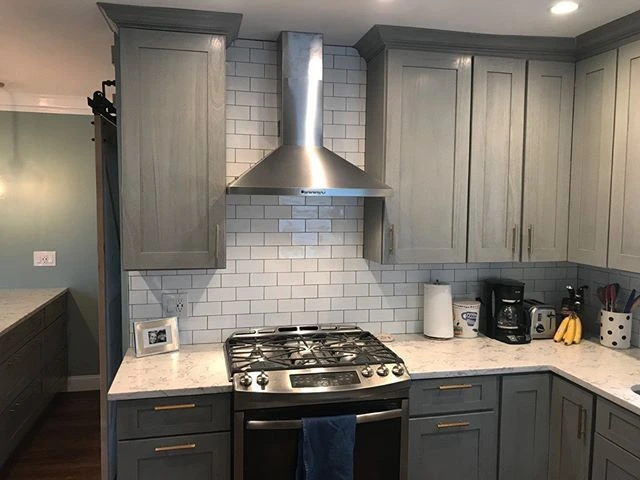Grey kitchen cabinets with stainless appliances in a Lyndhurst Ohio kitchen