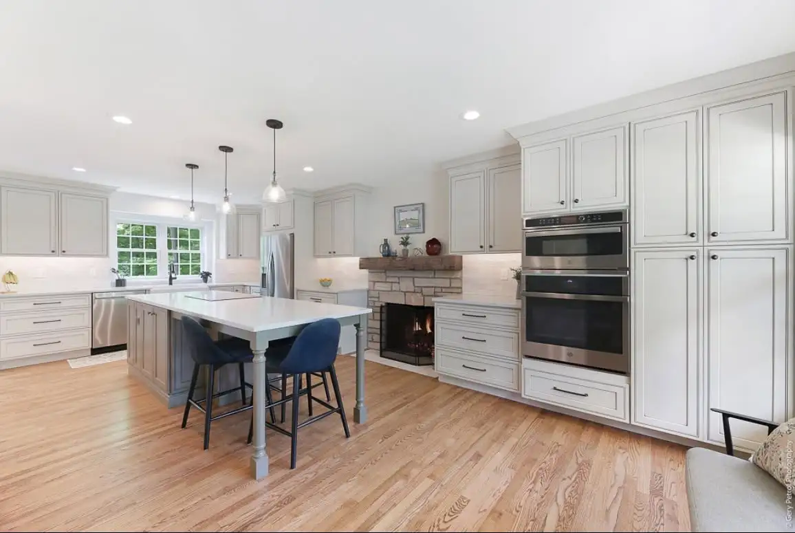 White kitchen cabinets with a blue island in a Bedford Heights Ohio kitchen